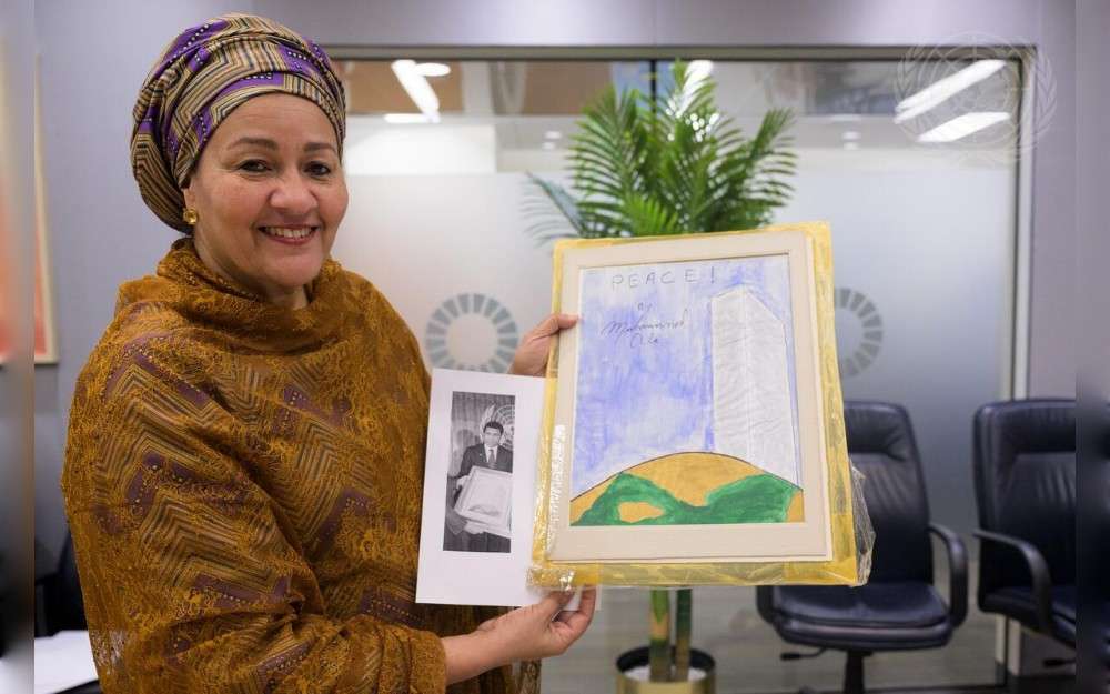 United Nations Deputy Secretary-General Amina Mohammed with an original work of art entitled “Peace”, painted by the boxer and UN Messenger of Peace Muhammad Ali.